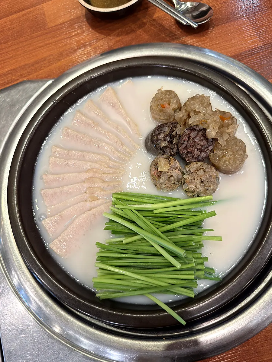 Pot filled with pork jowl, chives, and sundae