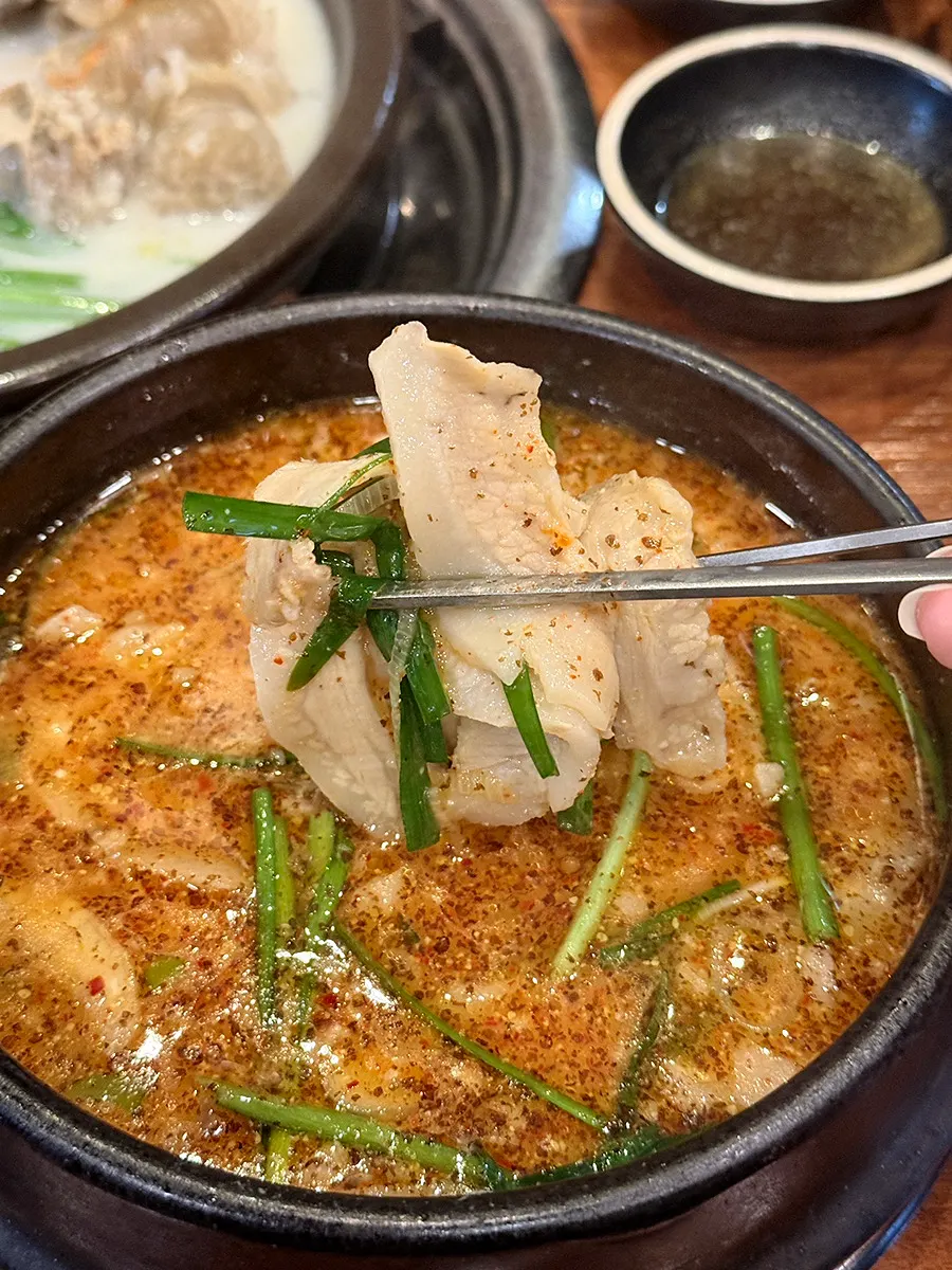A spoonful of the gukbap broth