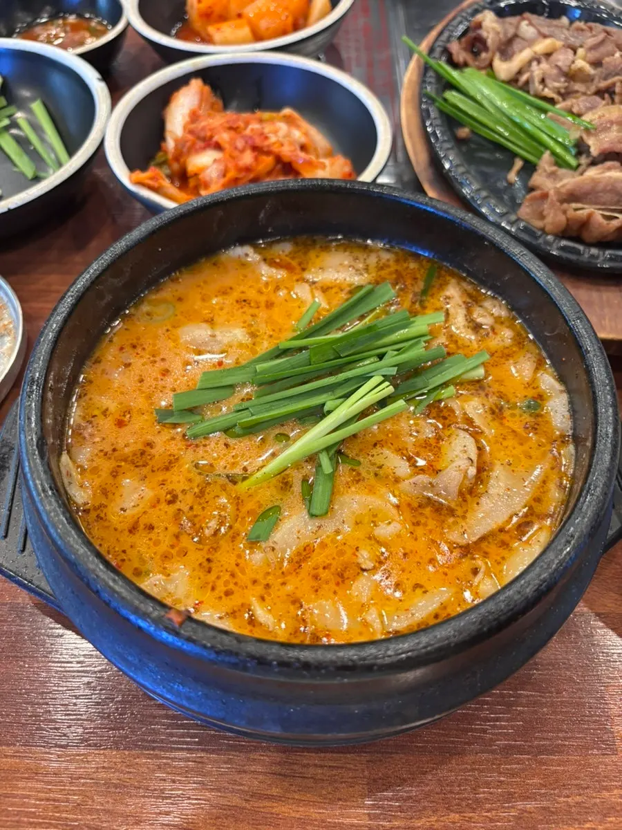 Close-up of pork jowl gukbap loaded with meat