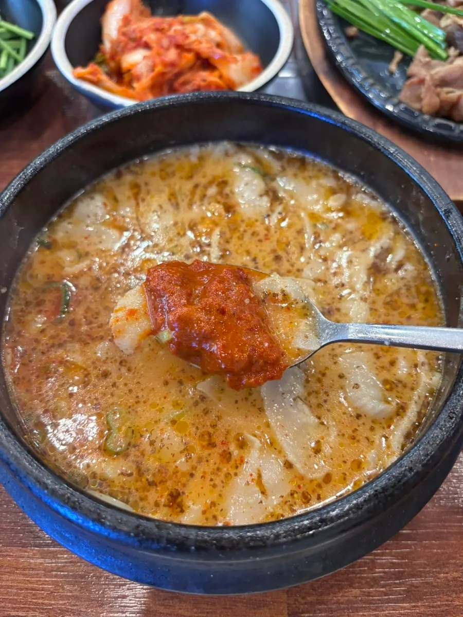 Lifting a piece of pork jowl with chopsticks