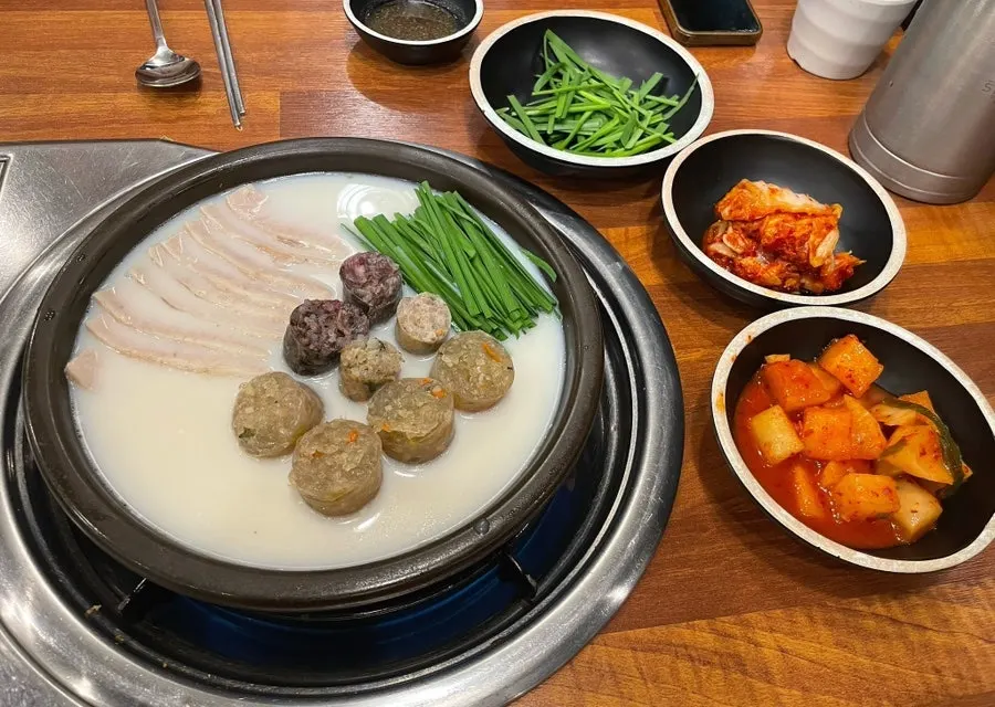 Pork jowl bossam simmering on a hot plate