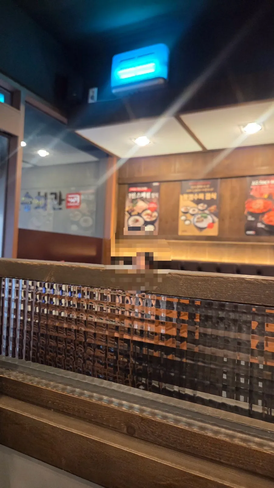 Wood-toned tables inside the gukbap restaurant