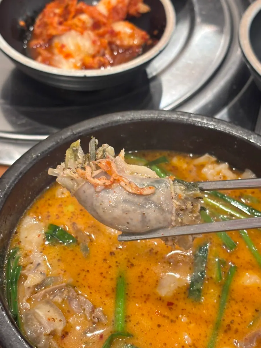 Bowl of sundae gukbap topped with chives