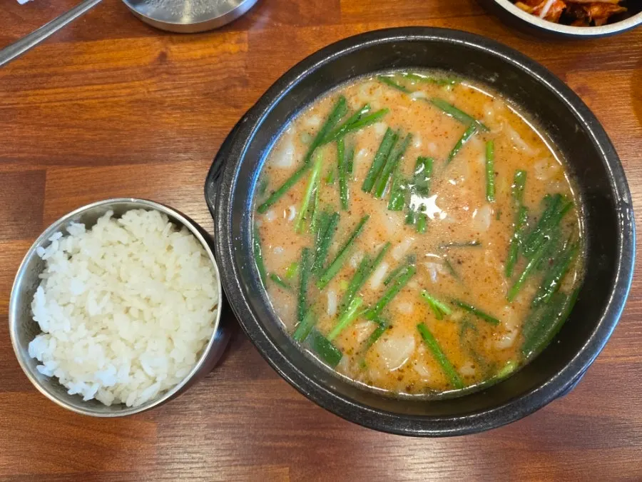 Close-up of tender hangjeong pork on top of the gukbap