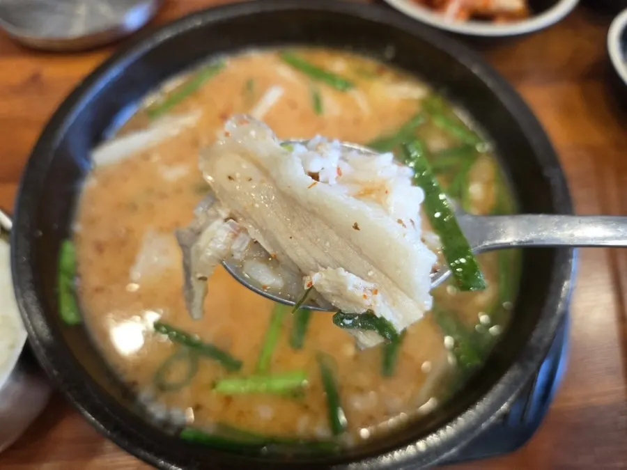 Hangjeong pork gukbap set on the table with side dishes