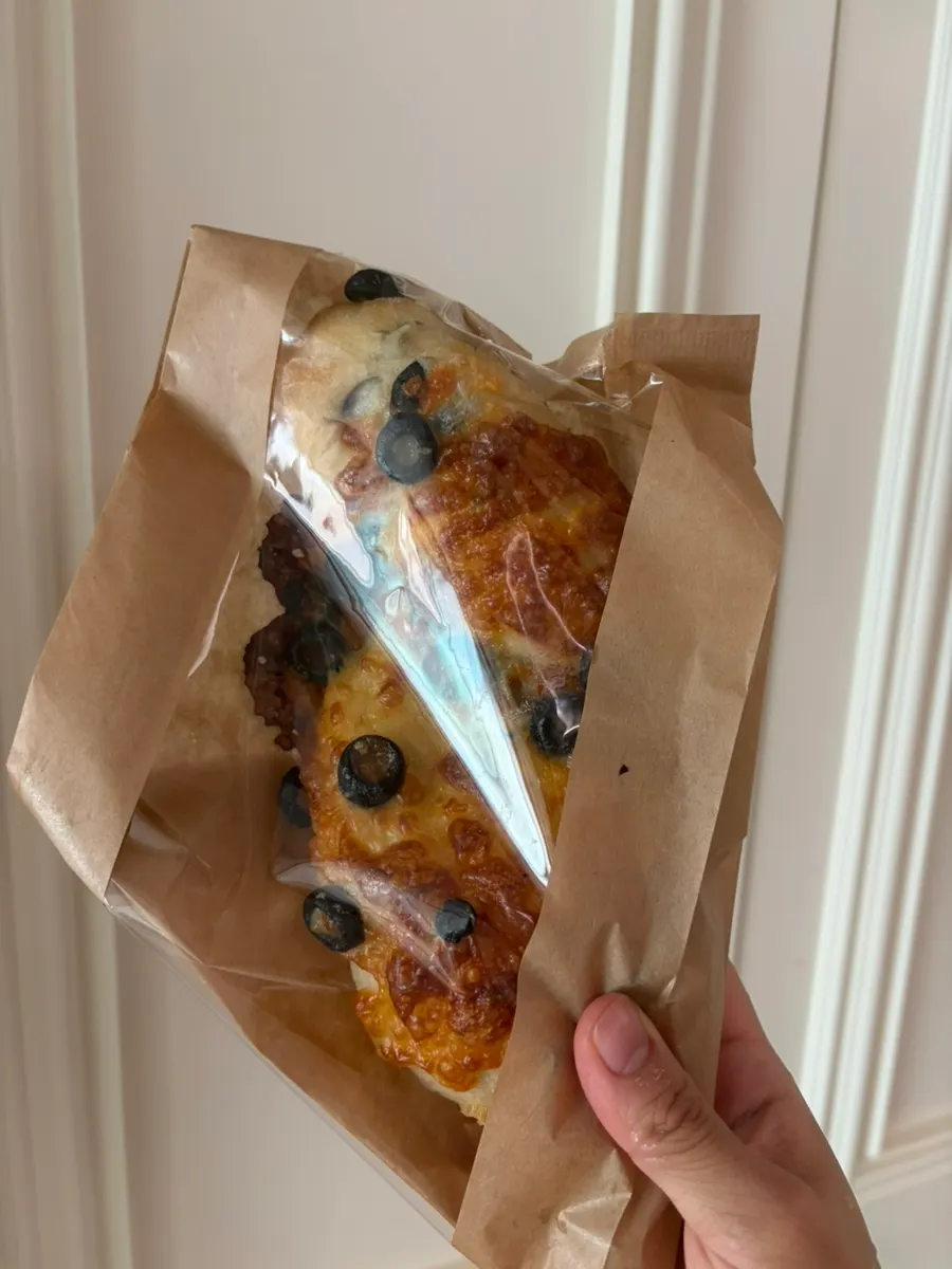 A heavy paper bag full of bread