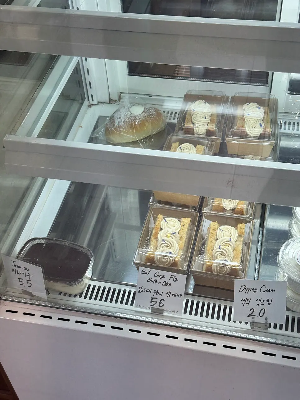 Display of strawberry jam, chestnut spread, and coffee beans for sale