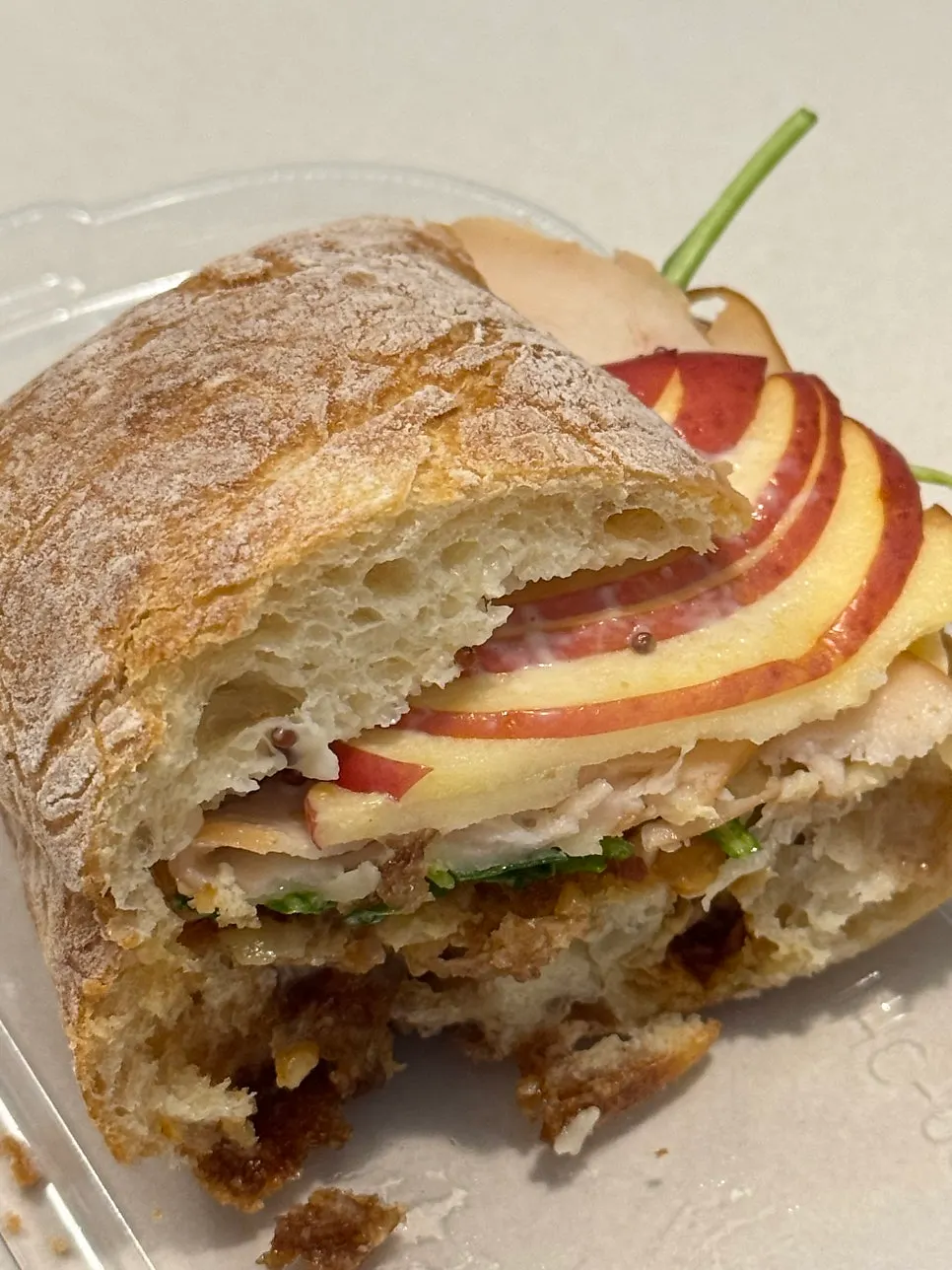 Inside of the sandwich showing ham and arugula