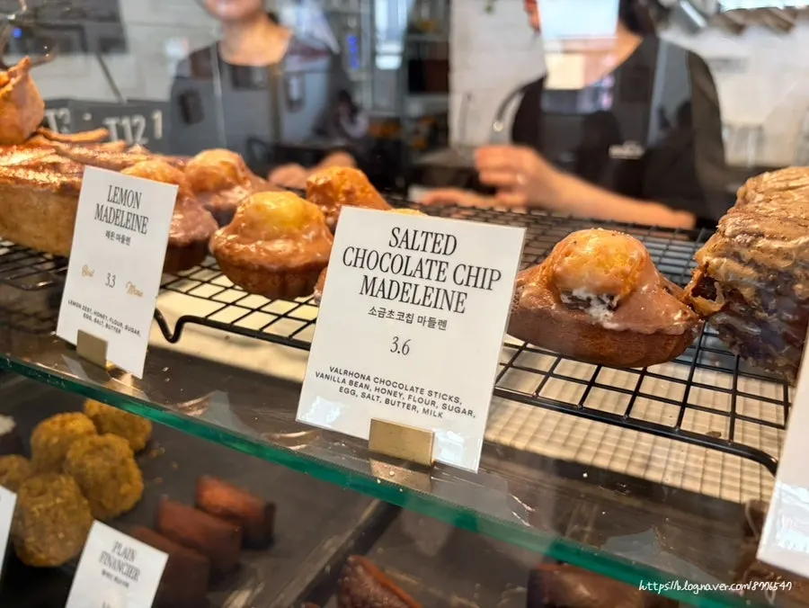 Display of assorted baked treats including canelés
