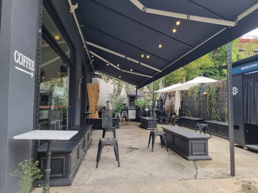 Empty outdoor terrace seating at Brewers Coffee