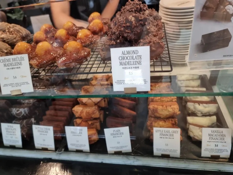 Dessert case with flan and canelé