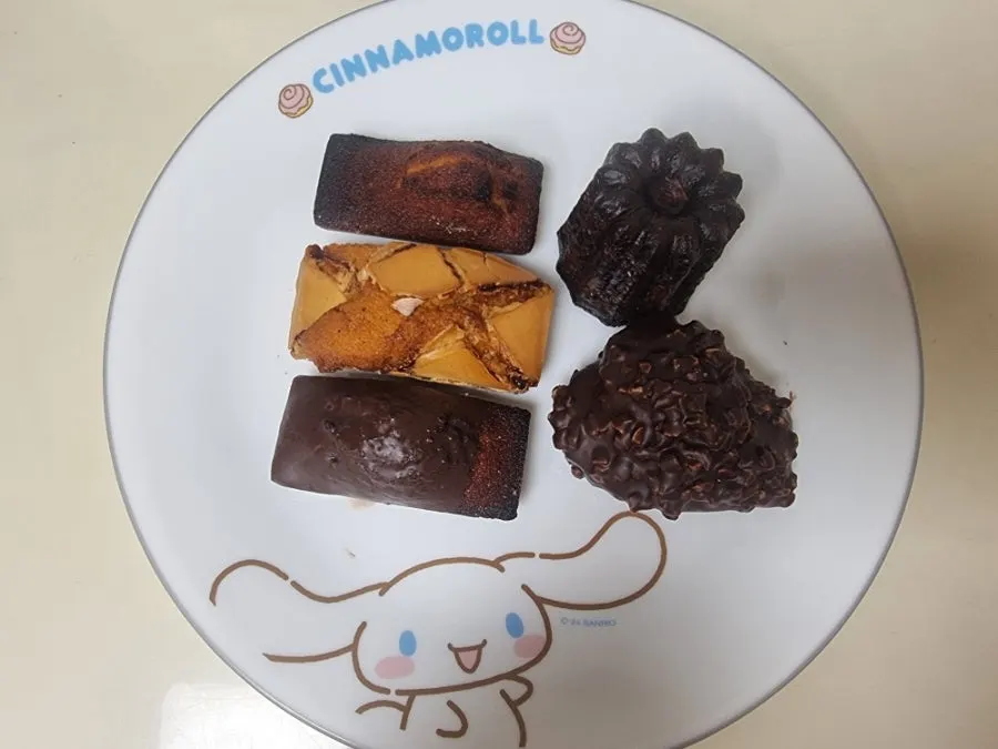 Five takeout baked treats with an iced americano