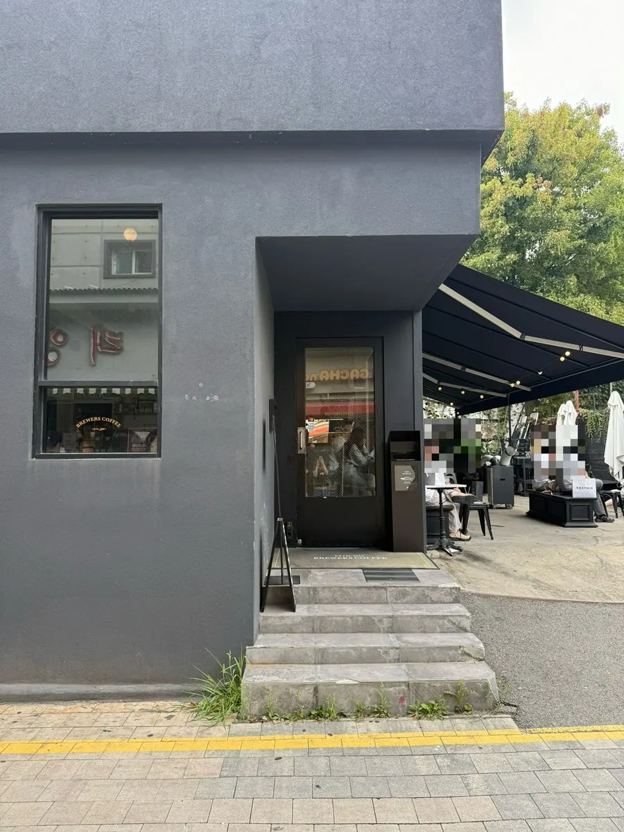 A customer seated at an outdoor table at Brewers Coffee
