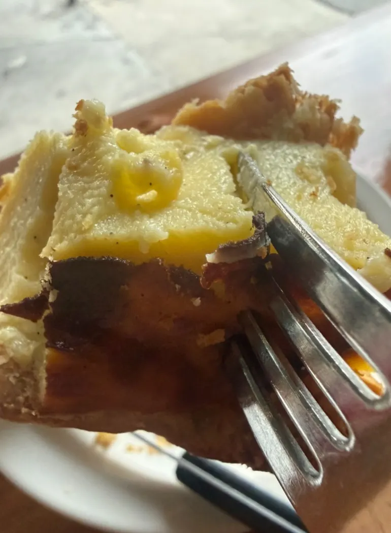 Plate of banana flan with a bite taken out