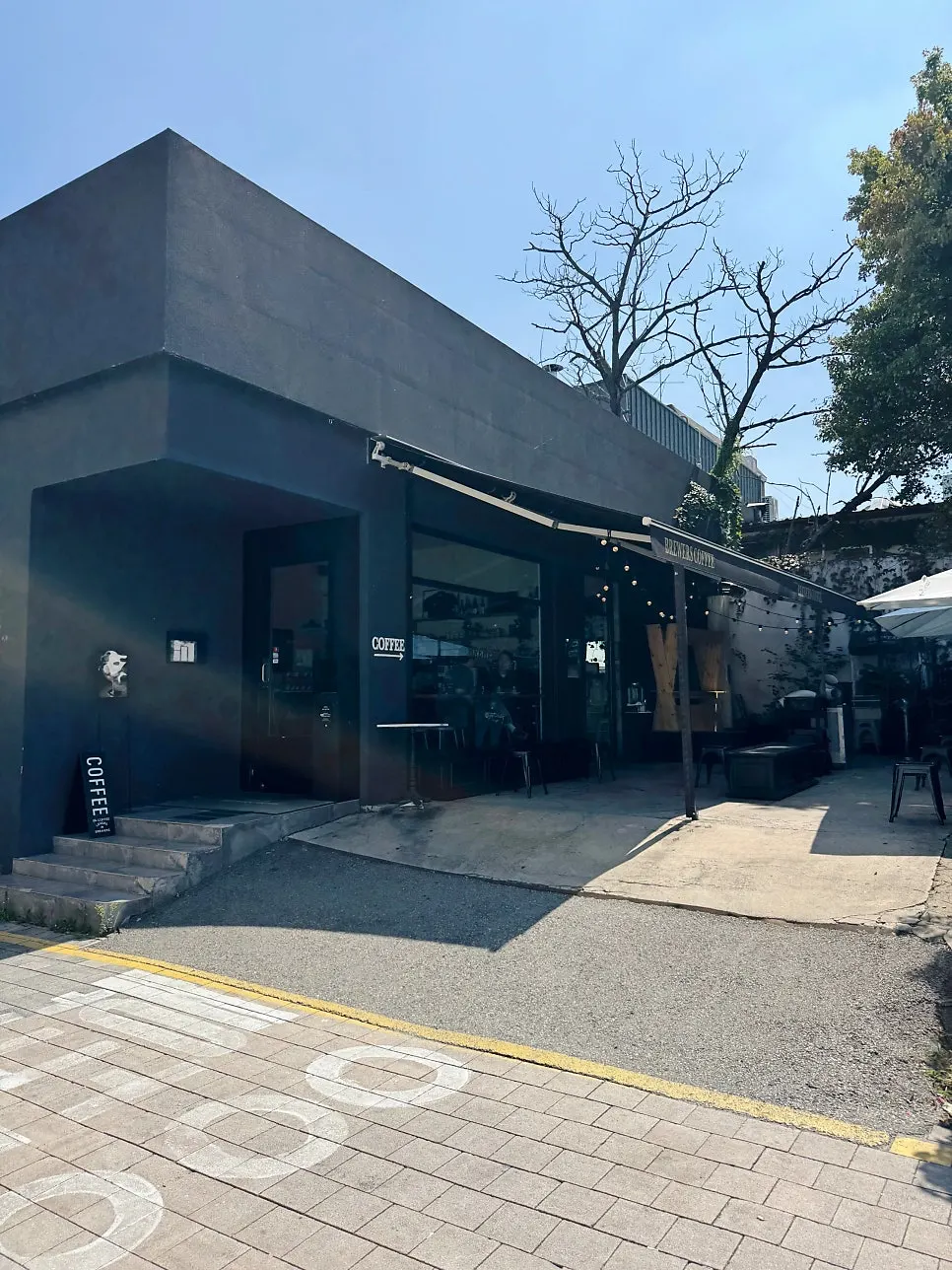 Black café building in a Sinbu-dong alley