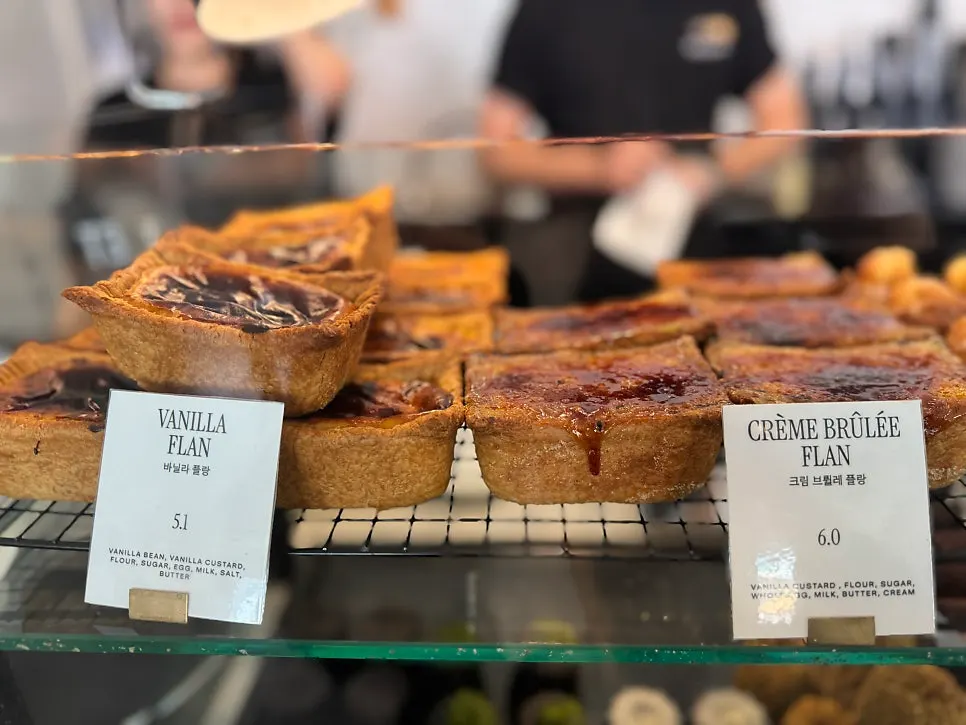 Financiers and canelés lined up in the display case