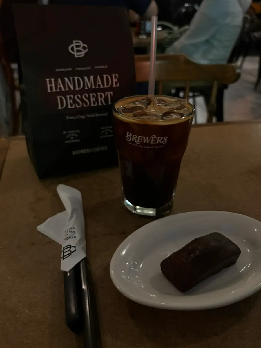 Iced Americano with salted caramel financier and vanilla canelé
