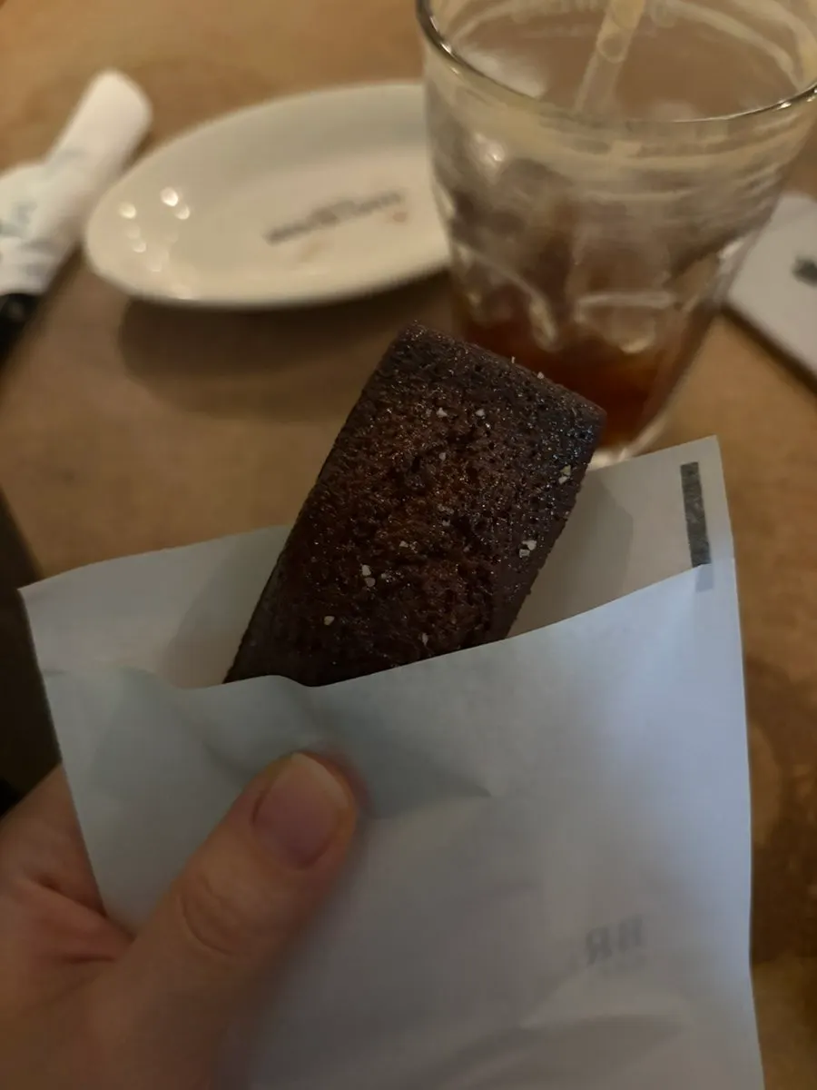 Financier and iced Americano on the table