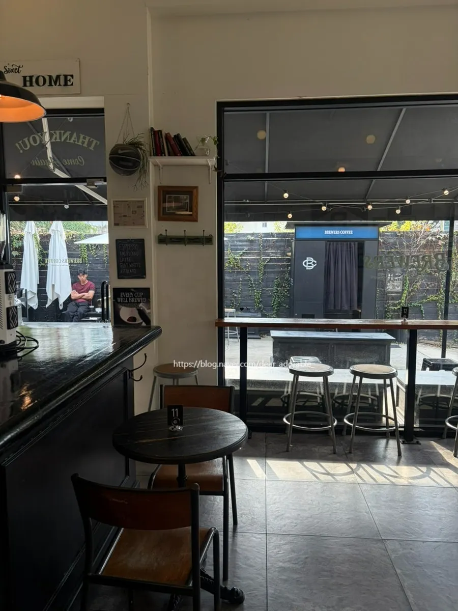 Fully seated interior of Brewers Coffee with customers