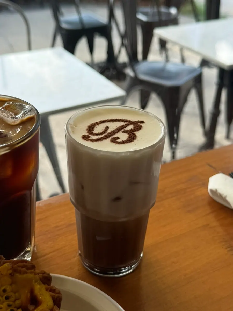 Coffee with crema in a cup engraved with the Brewers logo