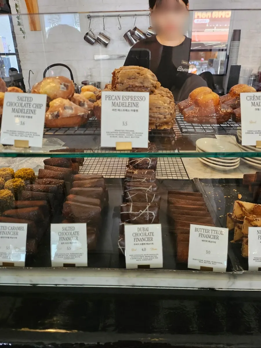 Dessert case with canelés on display