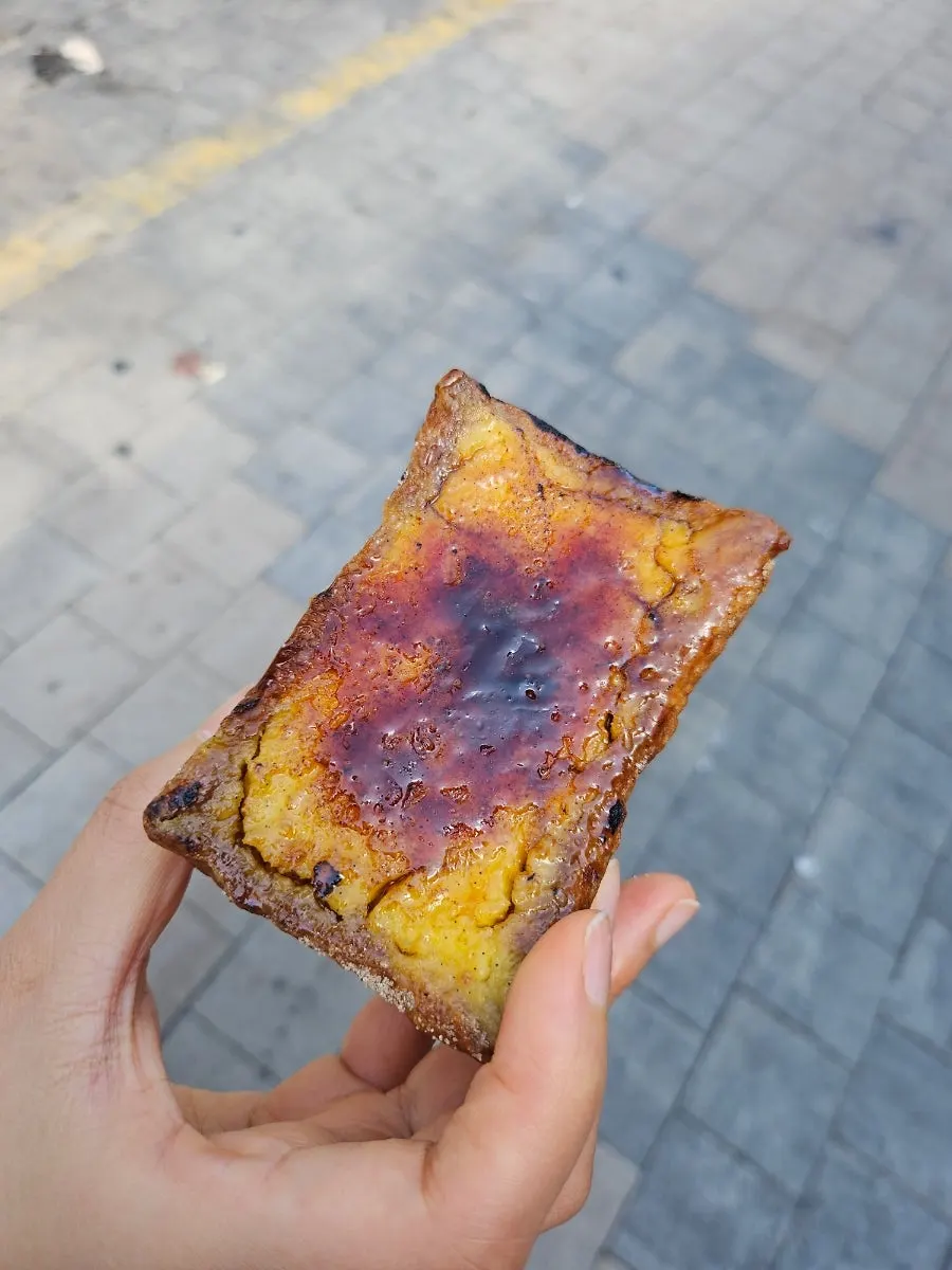 Crème brûlée flan next to an iced americano