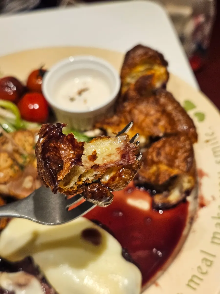 A piece of steak dipped in red wine sauce