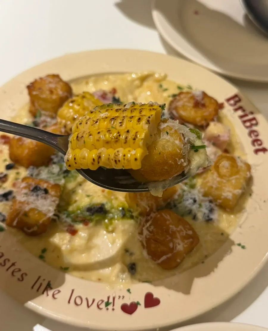 Green onion cream sauce with olives and bacon mixed in