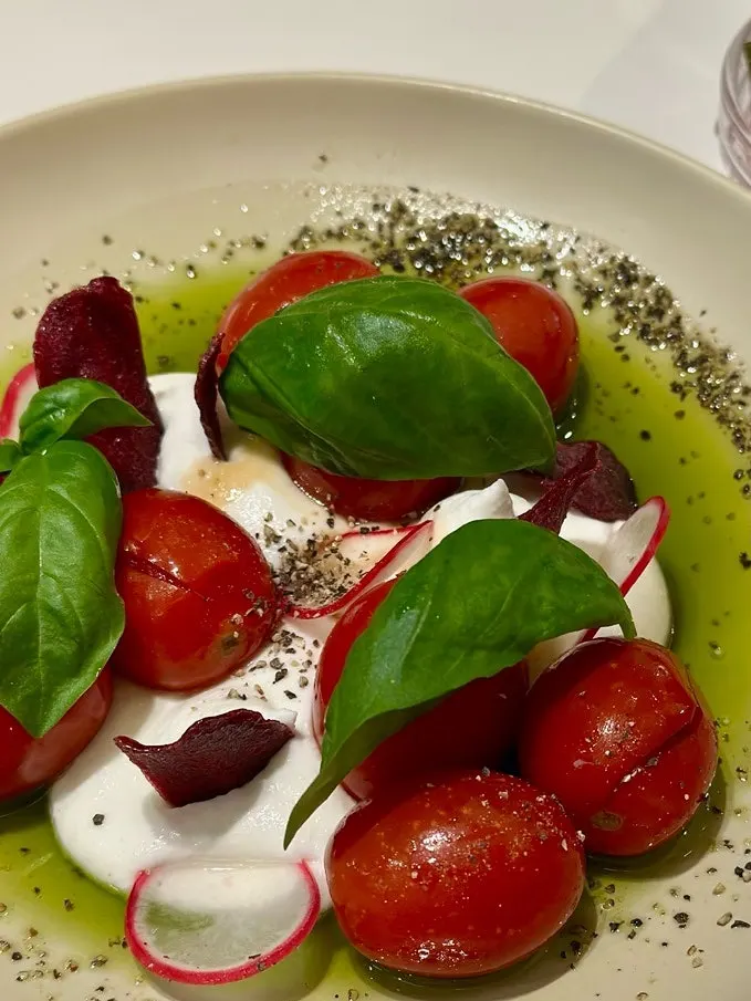Close-up of cherry tomatoes and basil in the salad