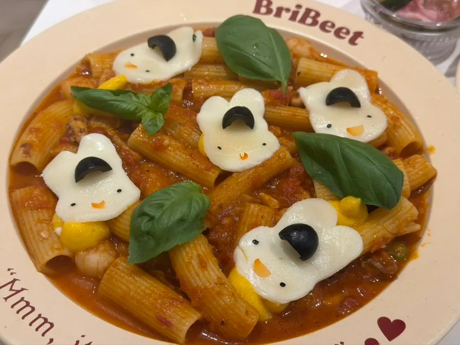 Rabbit-shaped mozzarella cheese on tomato sauce rigatoni