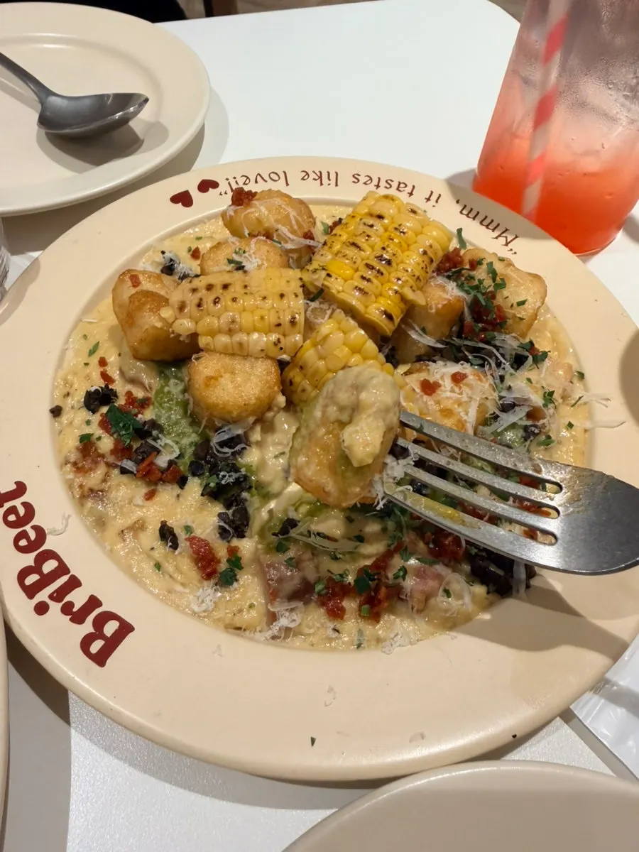 Corn cream gnocchi with green onion topped with roasted corn