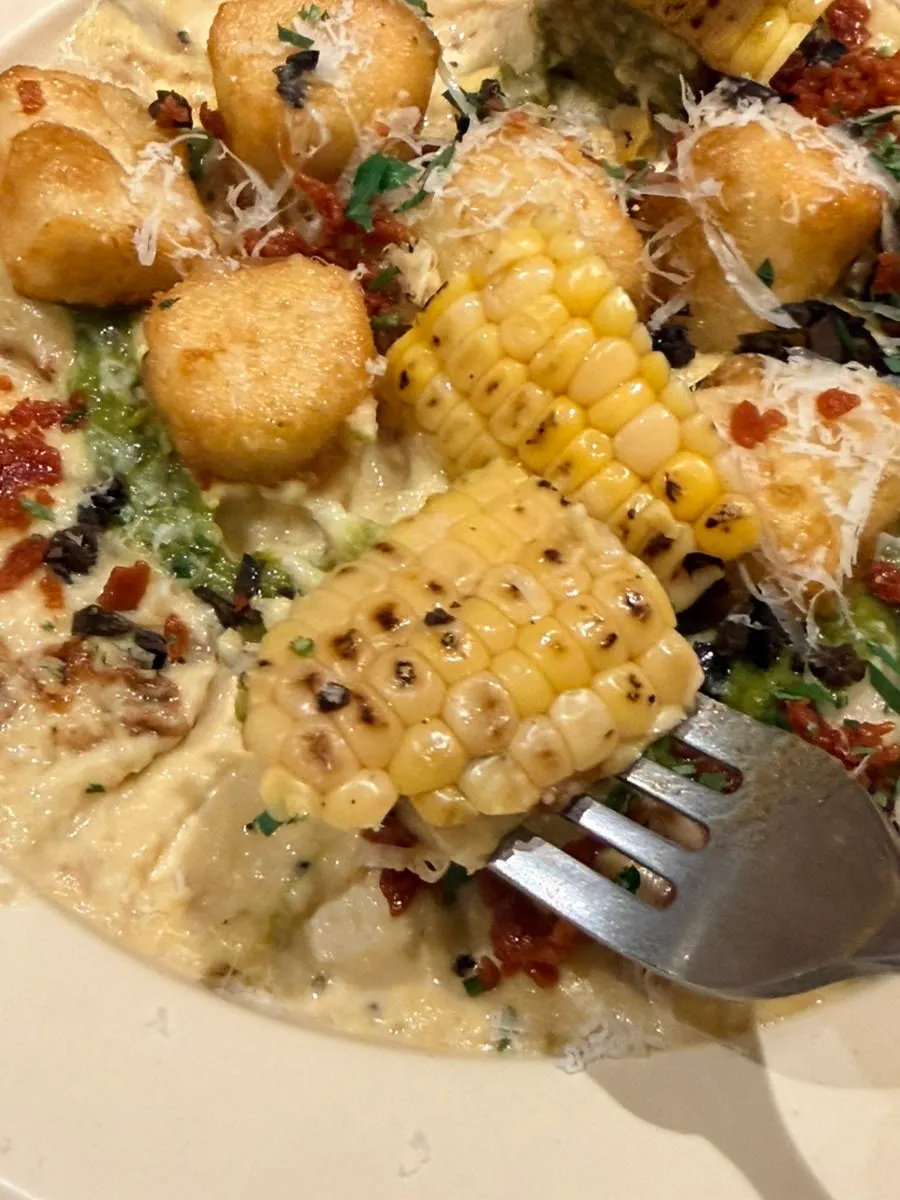 Close-up of the green onion cream gnocchi showing whole bacon chunks