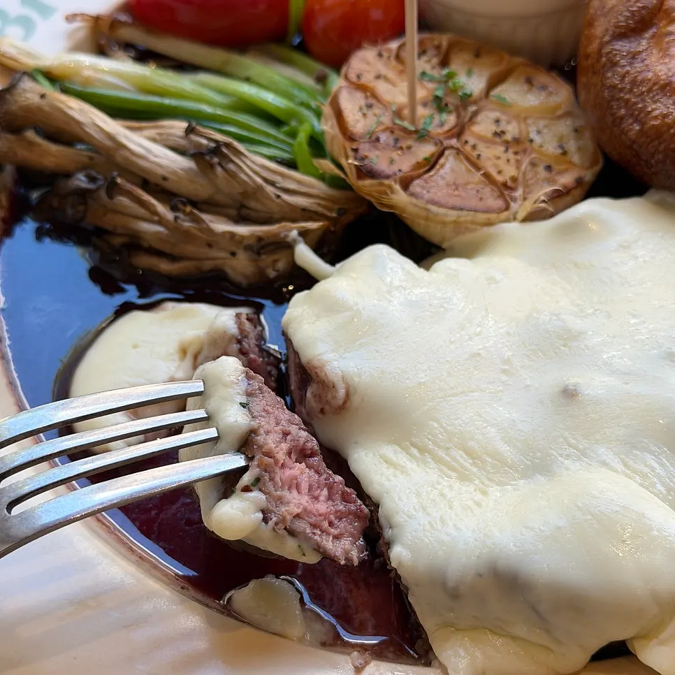 A piece of steak coated in red wine sauce