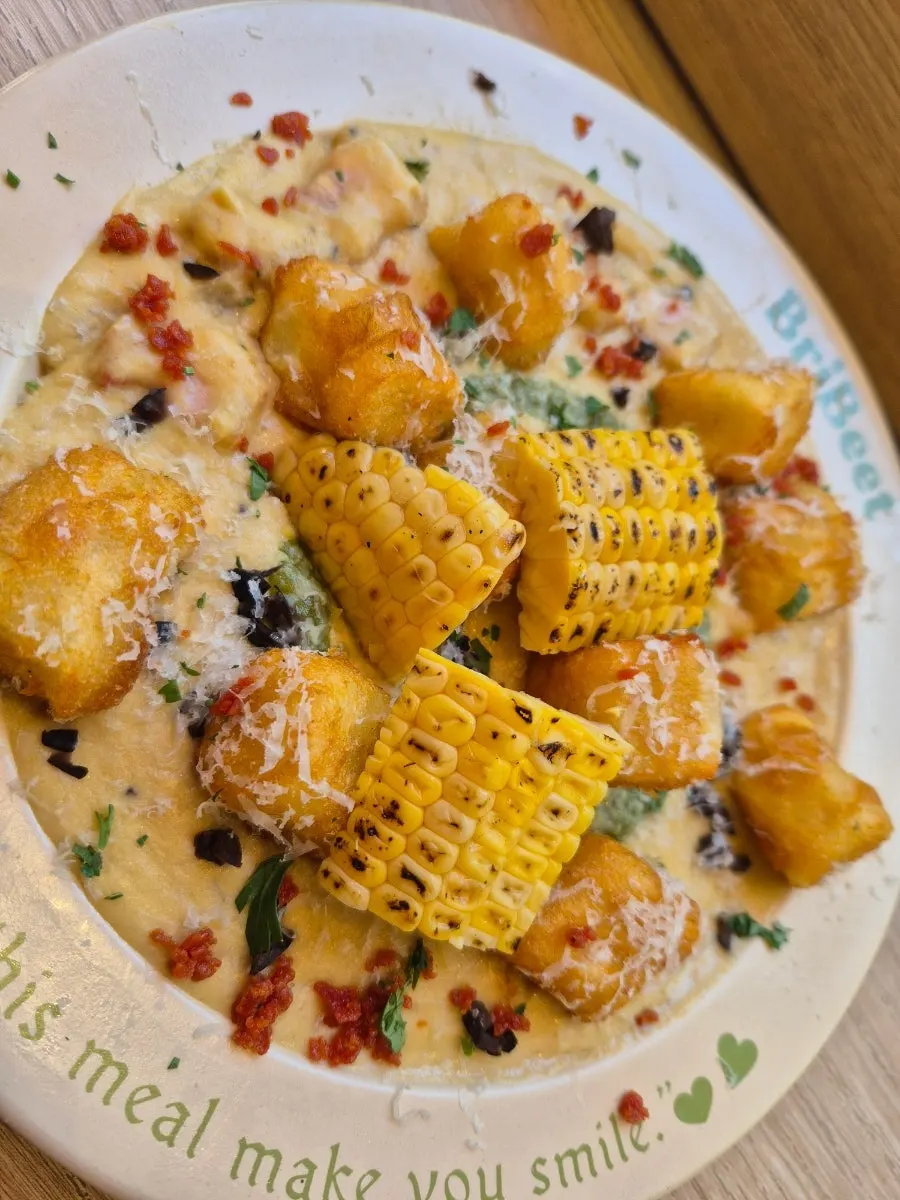 A forkful of corn gnocchi lifted up