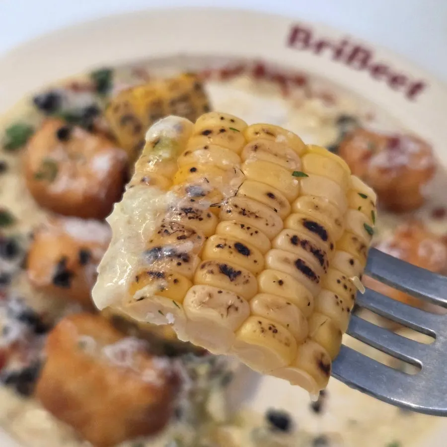 Close-up of gnocchi topped with corn