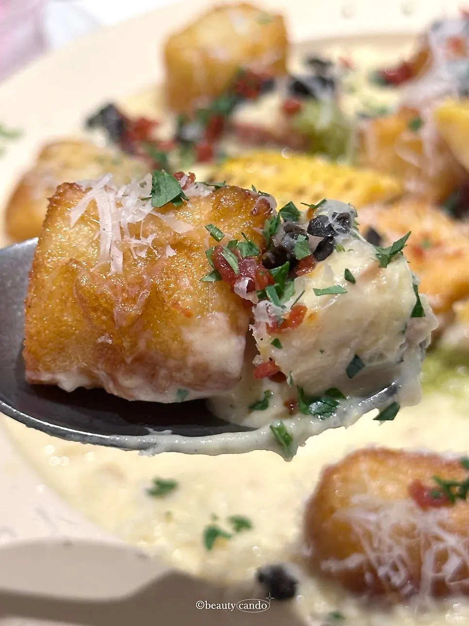 Corn cream gnocchi with green onion topped with whole bacon