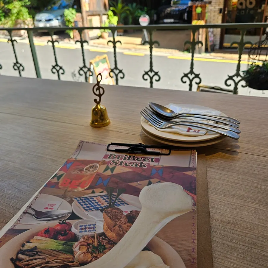 Two-person table with both steak and pasta placed together