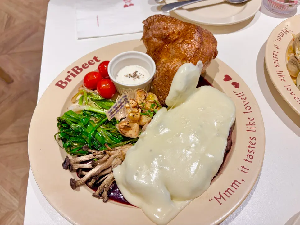 Brivit steak topped with a cheese waterfall