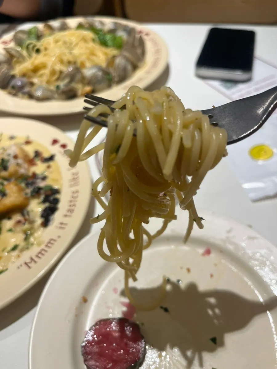 Lifting up a forkful of the vongole pasta noodles