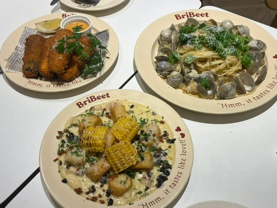 The full spread of eggplant, corn gnocchi and vongole ordered by three people