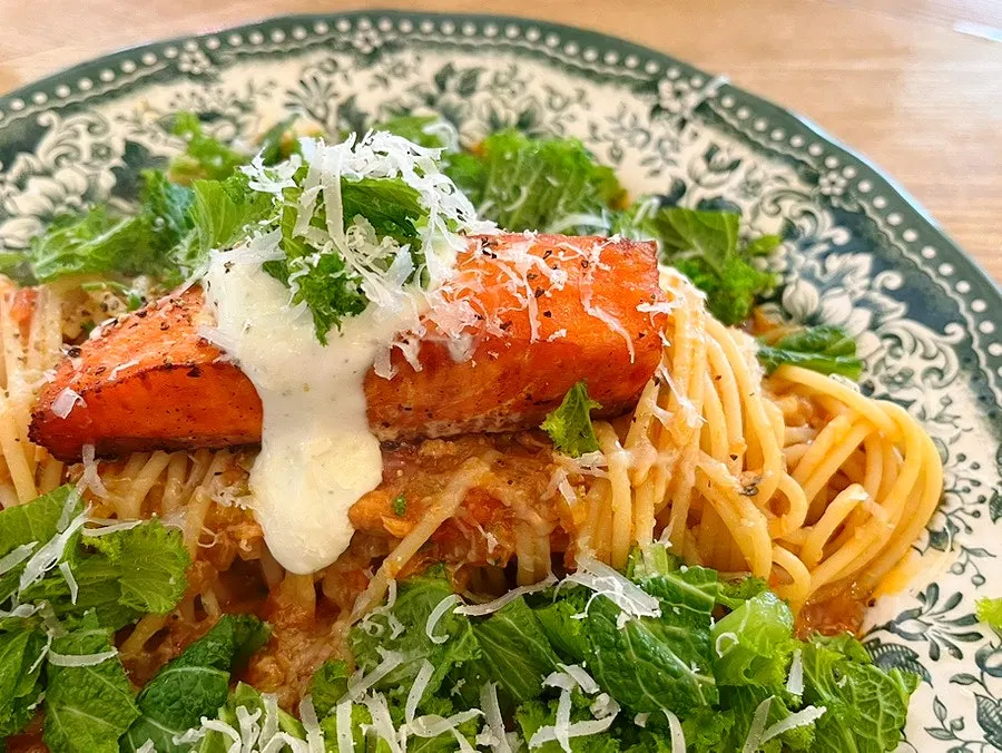 Greek yogurt tomato salad topped with basil