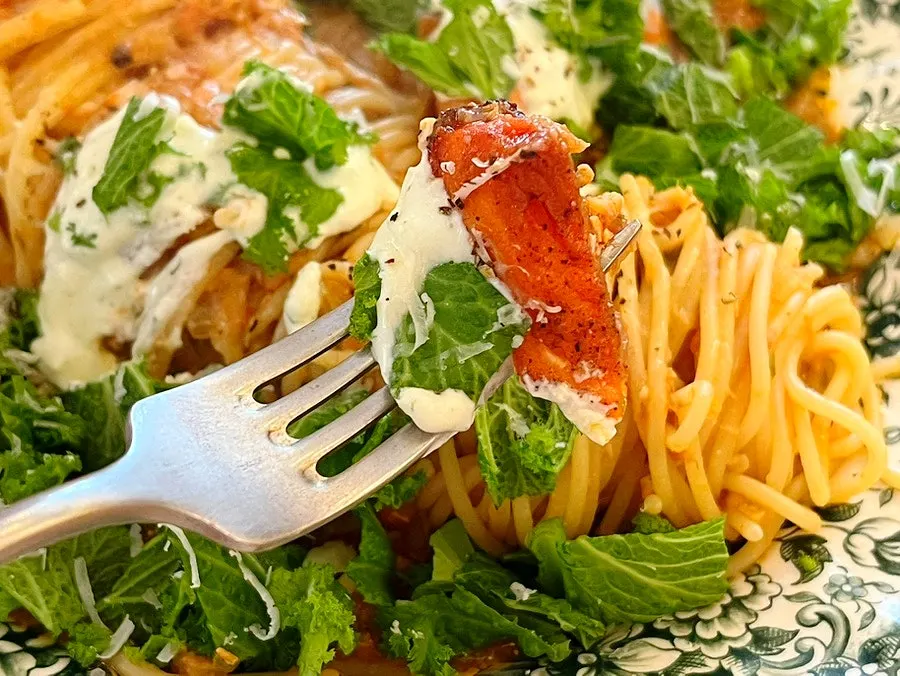 A plate of salmon steak pasta