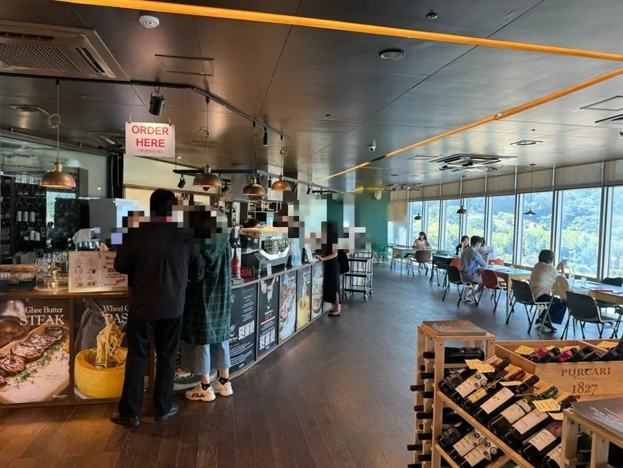 Window seating with a view of the Tongyeong sea through the glass wall