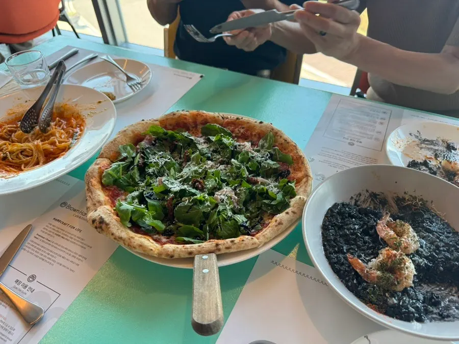 Table spread with pasta, risotto, and pizza together