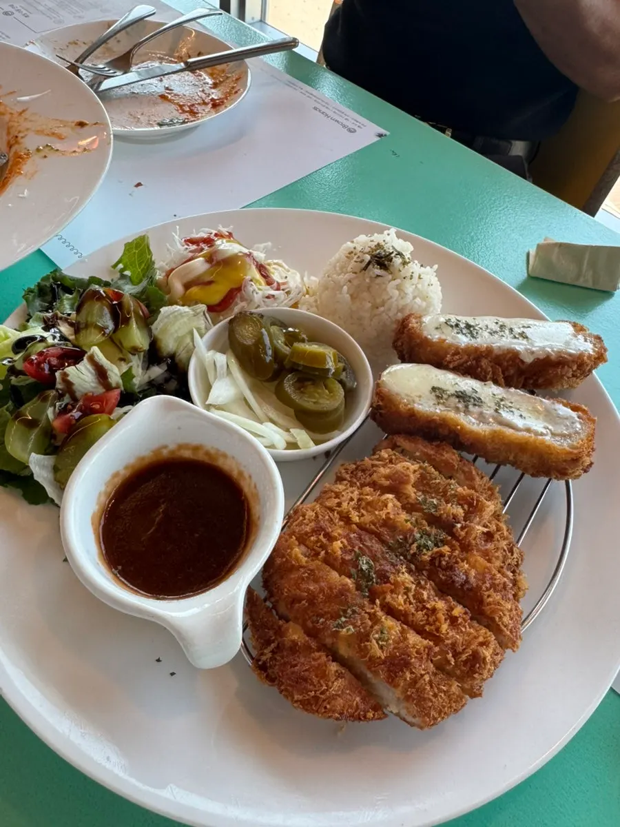 Pork cutlet plate served with salad and fruit