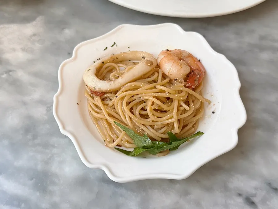 Myeongnan oil pasta topped with shrimp and scallops