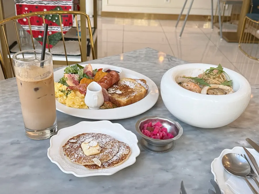 Table set for two with brunch and pasta together