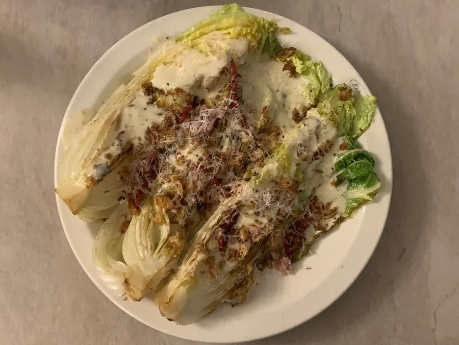 Napa cabbage caesar salad piled high with toppings