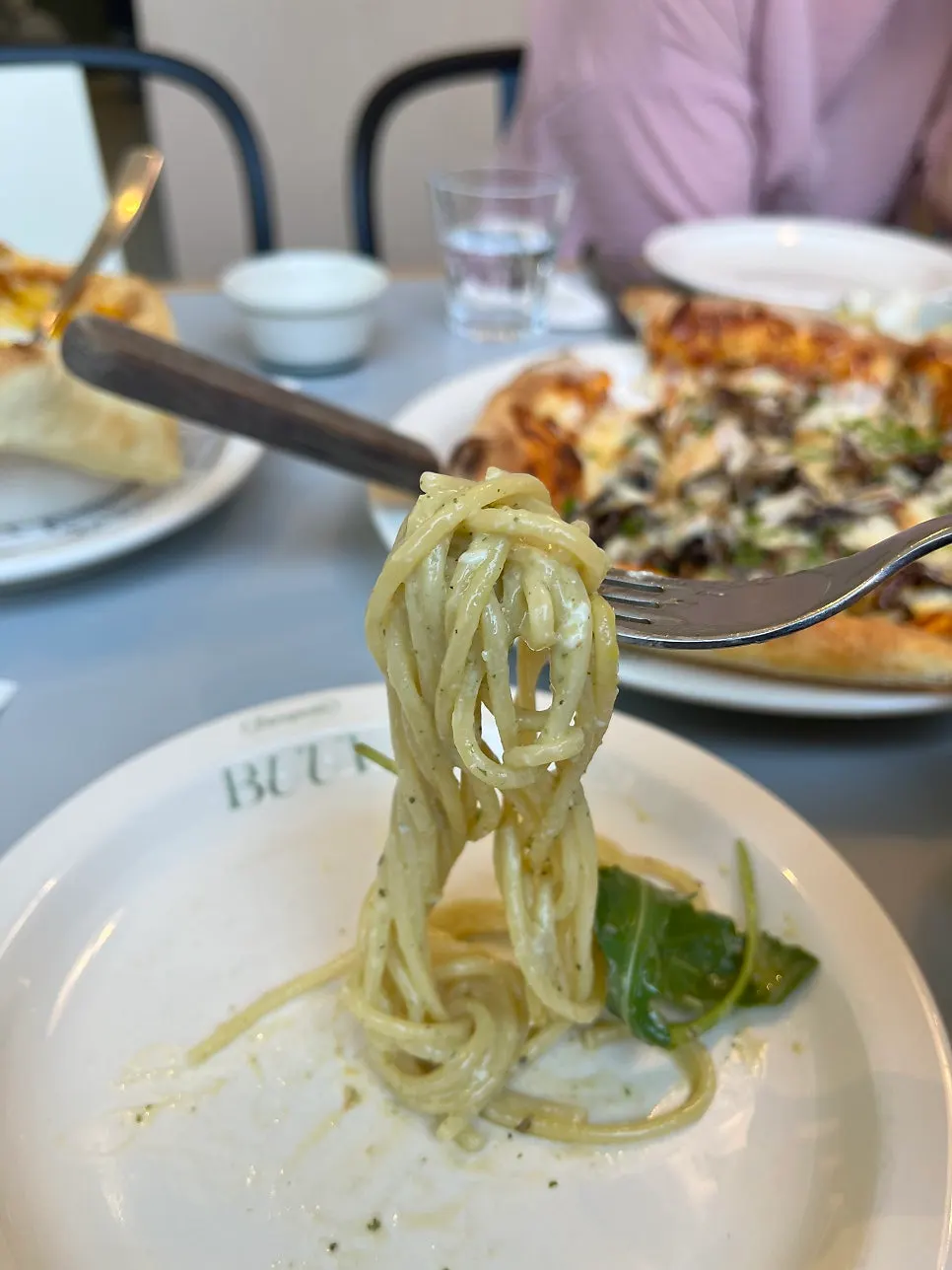 Cheese pull from a slice of truffle mushroom pizza