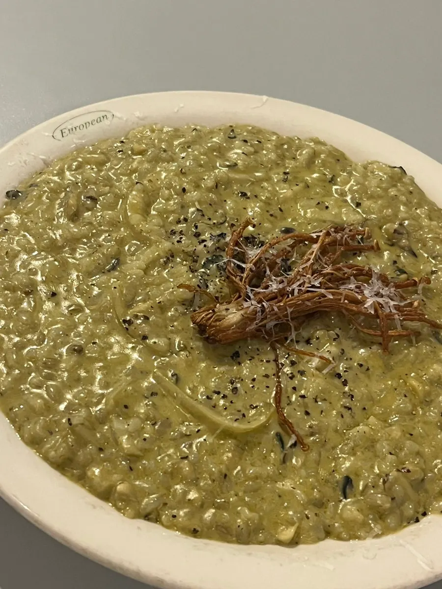 Abalone cream risotto topped with enoki mushroom garnish